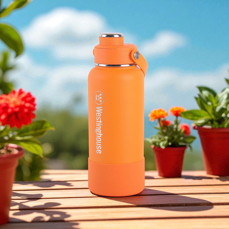 Botella térmica doble pared acero inoxidable 946 ml con boquilla y funda silicona naranja · Mantiene bebidas frías y calientes